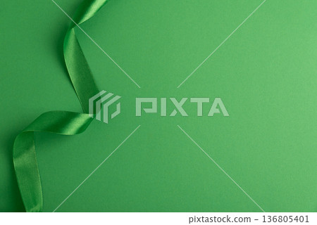 Green Satin Ribbon on Monochrome Background. Saint Patricks Day Decorative Concept 136805401