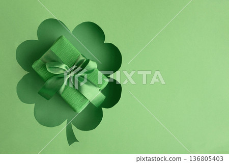 Green Gift Box in Clover Cutout. Festive St. Patricks Day Arrangement Green Gift Box in Clover Cutout. Festive St. Patricks Day Arrangement 136805403