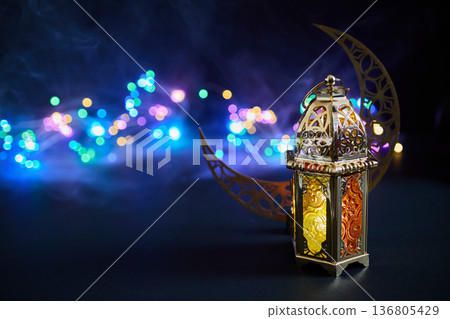 Ornate lantern and crescent moon celebrating ramadan Ornate lantern and crescent moon celebrating ramadan 136805429