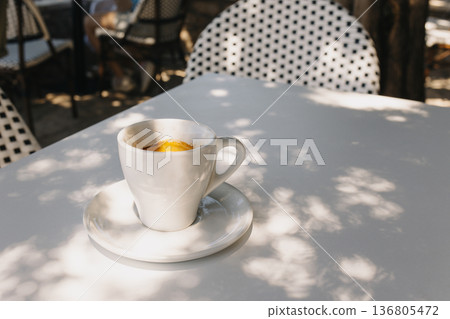 Cup of black coffee on a table in a street cafe. 136805472