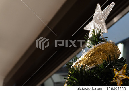 Christmas tree top with star and gold ribbon Christmas tree top with star and gold ribbon 136805533