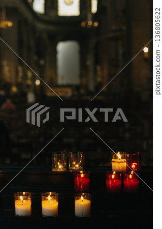 Burning candles in an old church. 136805622