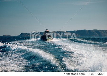 the coast of the Barents Sea, pleasure boats in the sea, the rocky shore with colourful arctic carpet of moss, yagel, Tundra at autumn the coast of the Barents Sea, pleasure boats in the sea, the rocky shore with colourful arctic carpet of moss, yagel, Tundra at autumn 136805666