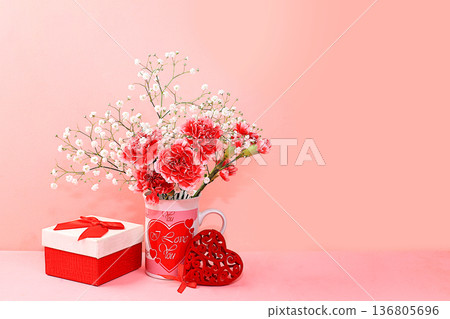Floral arrangement with carnations in a mug on a pink background. Concept for Valentine's Day or Women's Day, Mother's Day, banner, greeting your loved one on holiday, birthday, minimal modern design, Floral arrangement with carnations in a mug on a pink background. Concept for Valentine's Day or Women's Day, Mother's Day, banner, greeting your loved one on holiday, birthday, minimal modern design, 136805696