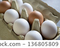White and brown fresh eggs. Nature background. Chicken egg in carton box for cooking healthy food. Bio organic eggs on the farm. Food concept. 136805809