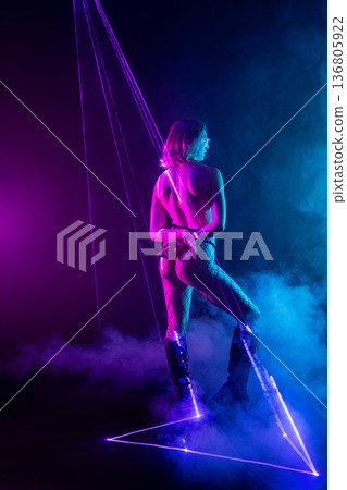Futuristic cyberpunk woman in neon laser light show Futuristic cyberpunk woman in neon laser light show 136805922