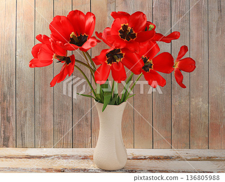 Abstract floral composition, blooming tulips in a vase on a light table, hello spring concept, template for design, still life with flowers, selective focus. Abstract floral composition, blooming tulips in a vase on a light table, hello spring concept, template for design, still life with flowers, selective focus. 136805988