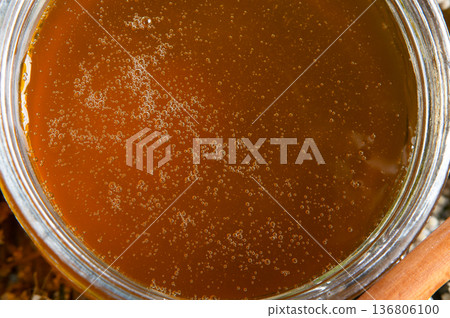 fresh natual flower honey in glass jar. extreme macro shot fresh natual flower honey in glass jar. extreme macro shot 136806100