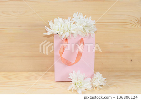 Flowers in a pink box, abstract spring floral background. Creative modern bouquet, minimal holiday concept. Greeting card for Women's Day or Mother's Day, Happy Birthday, Flowers in a pink box, abstract spring floral background. Creative modern bouquet, minimal holiday concept. Greeting card for Women's Day or Mother's Day, Happy Birthday, 136806124