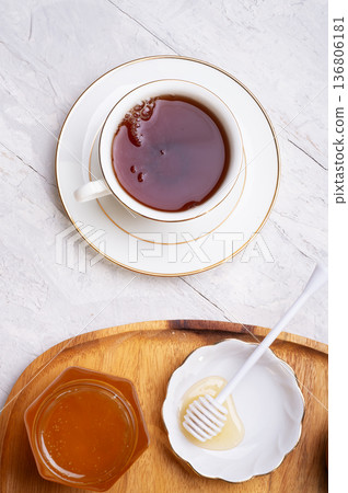 linden honey with cup of tea at wooden tray at white table. flat lay 136806181
