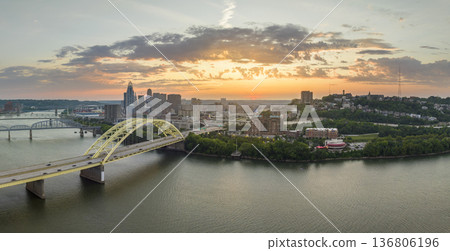 Night urban landscape of downtown district of Cincinnati city in Ohio, USA. Skyline with driving cars on bridge and brightly illuminated high skyscraper buildings in modern American megapolis Night urban landscape of downtown district of Cincinnati city in Ohio, USA. Skyline with driving cars on bridge and brightly illuminated high skyscraper buildings in modern American megapolis 136806196