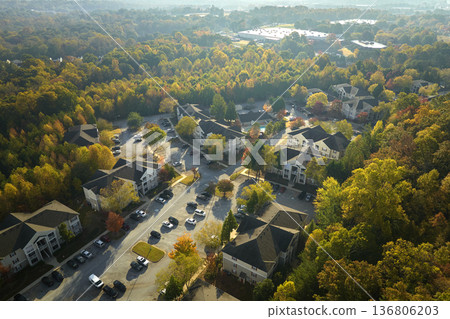 Aerial view of new apartment houses between yellow trees in South Carolina suburban area in fall season. Real estate development in american suburbs 136806203