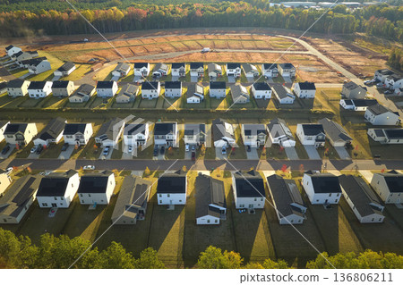 Real estate development with tightly located family houses under construction in South Carolina suburban area. Concept of growing american suburbs Real estate development with tightly located family houses under construction in South Carolina suburban area. Concept of growing american suburbs 136806211