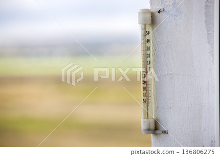 Alcohol glass thermometer Celsius outside on bright blurred light outdoors copy space background. Alcohol glass thermometer Celsius outside on bright blurred light outdoors copy space background. 136806275