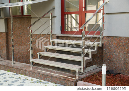 Detail of a house facade. New granite stairs with metal railings. Detail of a house facade. New granite stairs with metal railings. 136806295