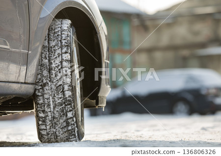 Close-up of car wheels rubber tire in deep snow. Transportation and safety concept. 136806326
