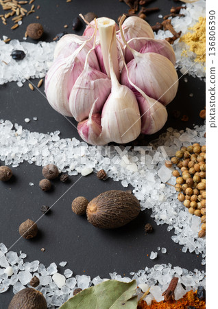 seasonings background with salt, Spices and garlic served at black. Colorful natural meal additives. healthy food concept. macro shot seasonings background with salt, Spices and garlic served at black. Colorful natural meal additives. healthy food concept. macro shot 136806390