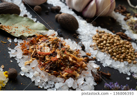 seasonings background with salt, Spices and garlic served at black. Colorful natural meal additives. healthy food concept. macro shot seasonings background with salt, Spices and garlic served at black. Colorful natural meal additives. healthy food concept. macro shot 136806393