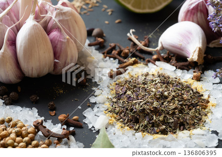 seasonings background with salt, Spices and garlic served at black. Colorful natural meal additives. healthy food concept. macro shot seasonings background with salt, Spices and garlic served at black. Colorful natural meal additives. healthy food concept. macro shot 136806395