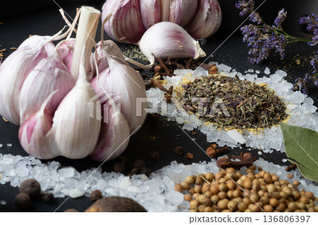 seasonings background with salt, Spices and garlic served at black. Colorful natural meal additives. healthy food concept. macro shot seasonings background with salt, Spices and garlic served at black. Colorful natural meal additives. healthy food concept. macro shot 136806397