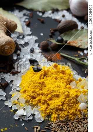 seasonings background with salt, Spices and garlic served  at black. Colorful natural meal additives. healthy food concept.  macro shot 136806405