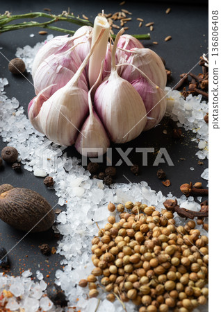 seasonings background with salt, Spices  and garlic served  at black. natural meal additives. healthy food concept. macro shot 136806408