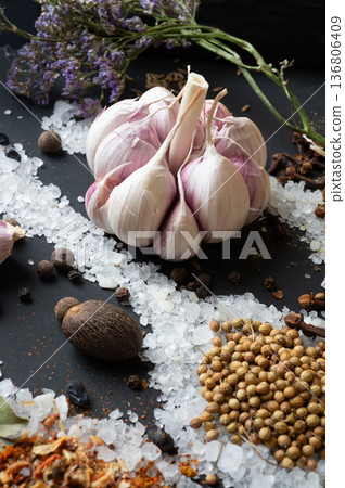 seasonings background with salt, Spices and garlic served at black. natural meal additives. healthy food concept. macro shot seasonings background with salt, Spices and garlic served at black. natural meal additives. healthy food concept. macro shot 136806409