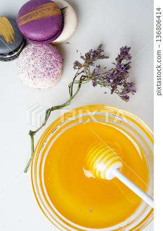 linden fresh honey with spoon and macaroons on white.  flat lay 136806414
