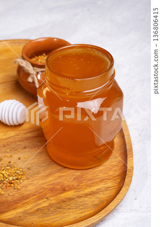 linden honey with perga at wooden tray at white table. close up 136806415