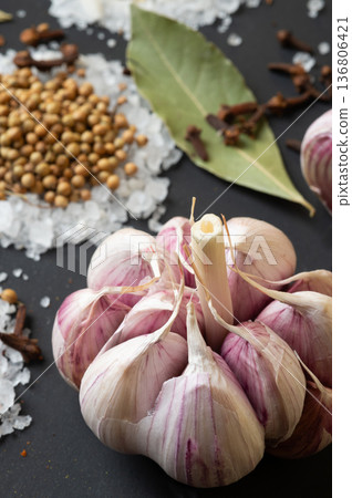 seasonings background with salt, Spices and garlic served at black. Colorful natural meal additives. healthy food concept. macro shot seasonings background with salt, Spices and garlic served at black. Colorful natural meal additives. healthy food concept. macro shot 136806421