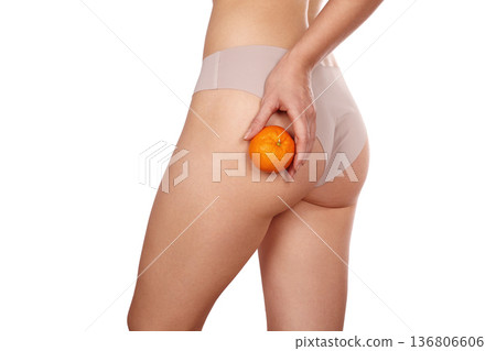 Body Care, Woman Health, Pinching Cellulite Holding Orange. Wellness Campaign, Nutritionist Role. Skin Dimpling, Firmness And Texture Differences. Wellness, Message Cellulite Contrast Through Citrus Body Care, Woman Health, Pinching Cellulite Holding Orange. Wellness Campaign, Nutritionist Role. Skin Dimpling, Firmness And Texture Differences. Wellness, Message Cellulite Contrast Through Citrus 136806606