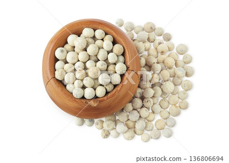 White peppercorns or pepper in wooden bowl isolated on white background. Top view. Flat lay White peppercorns or pepper in wooden bowl isolated on white background. Top view. Flat lay 136806694
