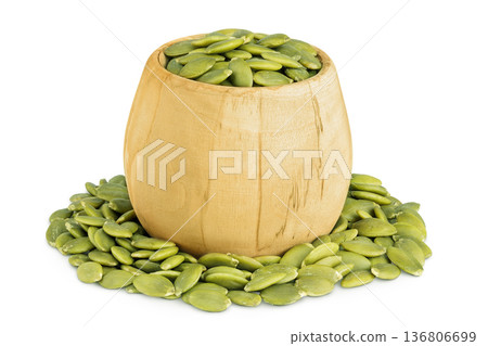 Peeled pumpkin seeds in wooden bowl isolated on white background 136806699