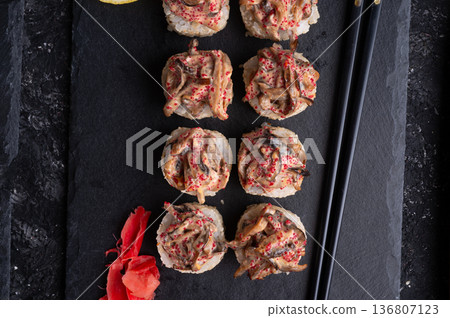 sushi roll  with shiitake mushrooms  served  at black dish  at black table. flat lay. close up 136807123