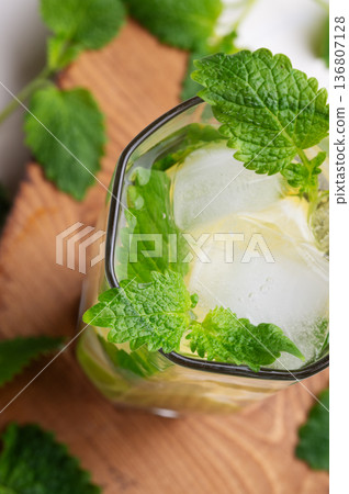 fresh lemonade served  in glass with  melissa and   ice . macro shot. top view 136807128