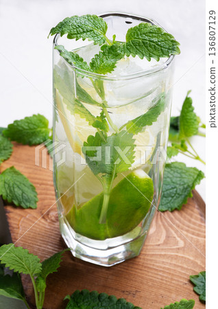 fresh lemonade served in glass with melissa and ice . close up studio shot fresh lemonade served in glass with melissa and ice . close up studio shot 136807129