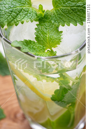 fresh lemonade served  in glass with  melissa and   ice . macro shot 136807131
