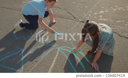Kid child baby boy girl, Little artists at work, boy and girl sketching, sidewalk creation, childhood memories, playful teamwork, chalk adventure, outside drawing concept, fun and creative moment Kid child baby boy girl, Little artists at work, boy and girl sketching, sidewalk creation, childhood memories, playful teamwork, chalk adventure, outside drawing concept, fun and creative moment 136807419