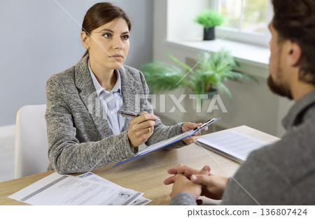 Job interview, discussion of recruiter and candidate on meeting in HR office 136807424