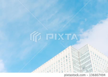A modern white building against the expansive blue sky - an image of growth and progress 136807494