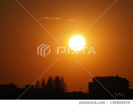 The sun setting in the city The sun setting in the city 136808939