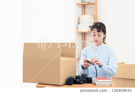 A woman sorting out unnecessary items 136809643