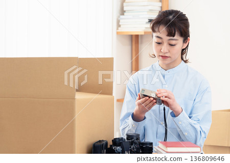 一位女士正在整理不需要的物品。 136809646