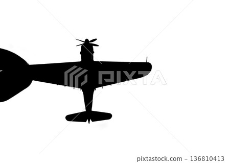 Silhouette of a propeller fighter plane pinched between fingers Silhouette of a propeller fighter plane pinched between fingers 136810413