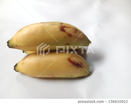 Two ripe bananas with yellow peels and natural brown spots, tropical fruit perfect for healthy eating. Two ripe bananas with yellow peels and natural brown spots, tropical fruit perfect for healthy eating. 136810922