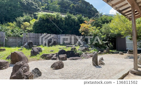 一個美麗的日式庭園,有枯山水庭園和石雕作品。 一個美麗的日式庭園,有枯山水庭園和石雕作品。 136811502