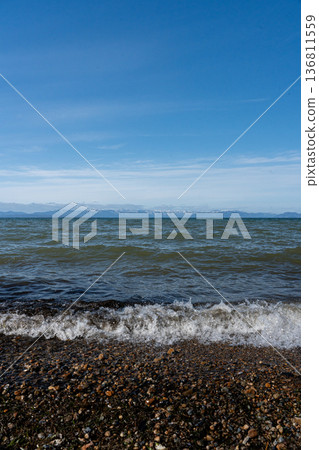 Lake Biwa in midwinter and the snowy mountains of Kohoku in the distance Lake Biwa in midwinter and the snowy mountains of Kohoku in the distance 136811559