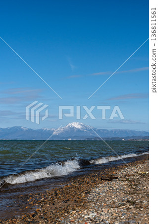 Lake Biwa in midwinter and the snowy mountains of Kohoku in the distance Lake Biwa in midwinter and the snowy mountains of Kohoku in the distance 136811561