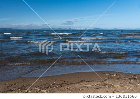 Lake Biwa in midwinter and the snowy mountains of Kohoku in the distance Lake Biwa in midwinter and the snowy mountains of Kohoku in the distance 136811566