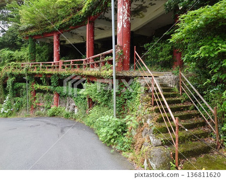 A view of a dilapidated building nestled in the mountains A view of a dilapidated building nestled in the mountains 136811620